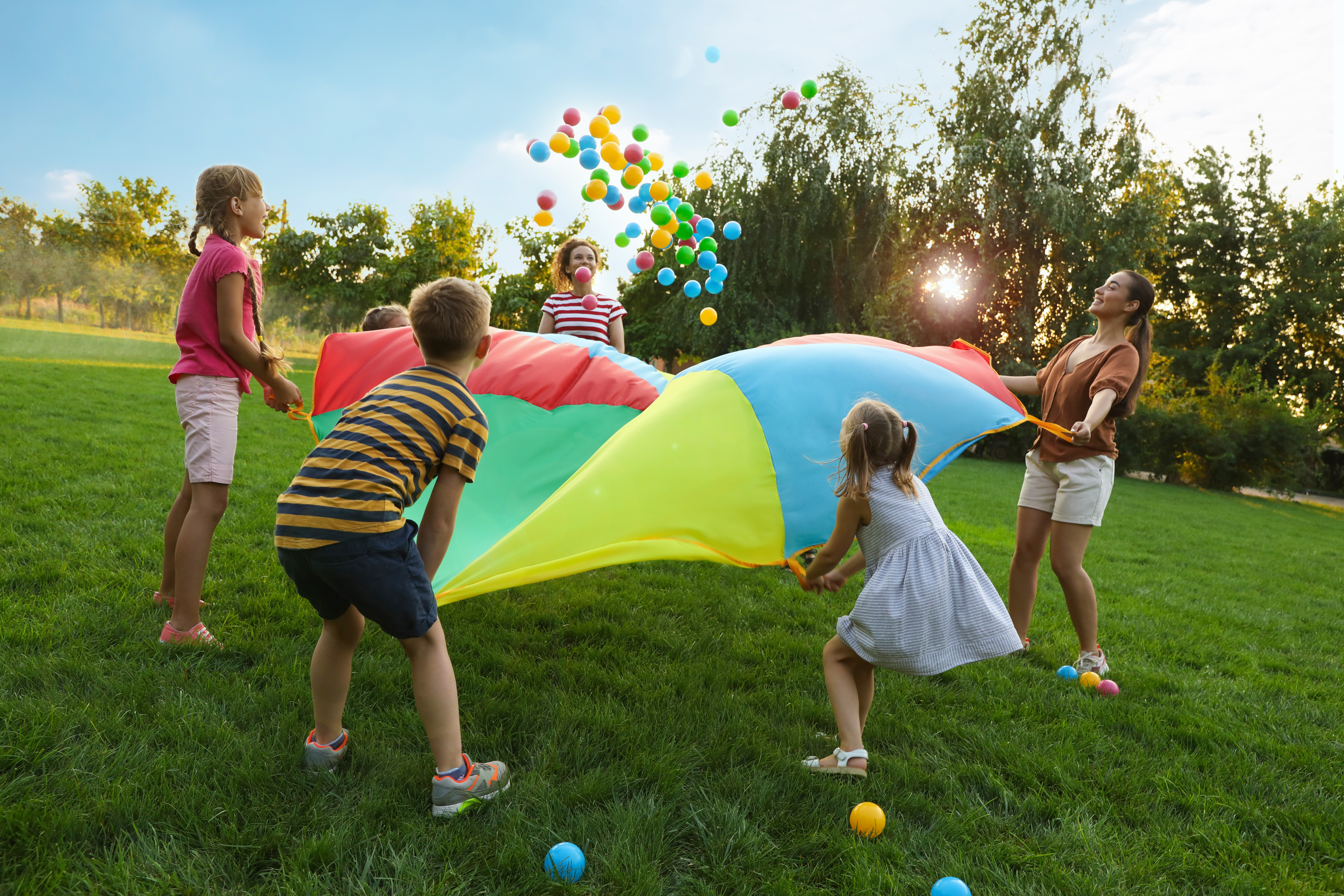 kids playing with a parachute